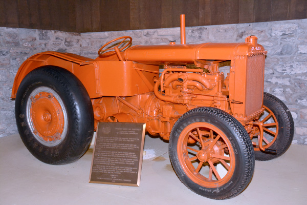 An orange tractor on display