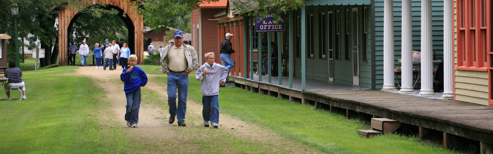 A group of guests walk down a dirt road